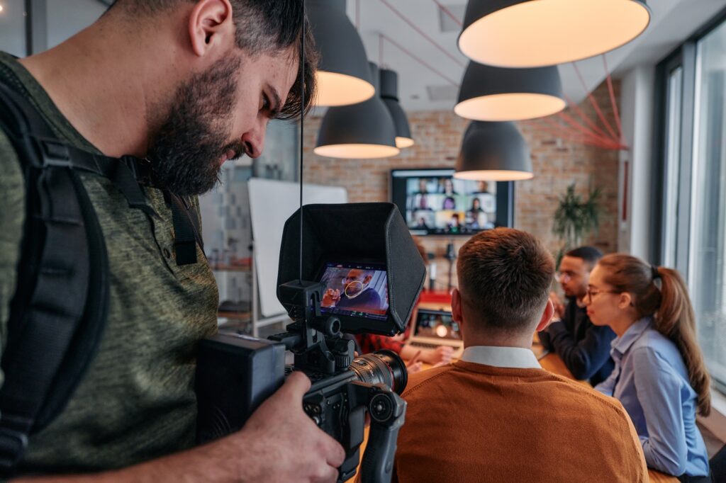 Capturing Corporate Dynamics: Videographer Films Business Meeting in Modern Office.